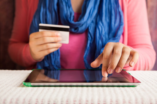 Woman buy in online shop in internet with tablet and credit card
