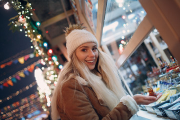 Young woman shopping at New Year Fair