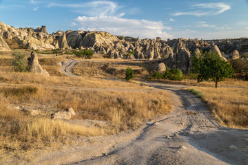 Dirt road through a valley with rock formations in Cappadocia, Turkey