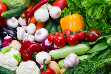 Fresh vegetables background close-up of tomatoes, cucumbers, onions, mushrooms 