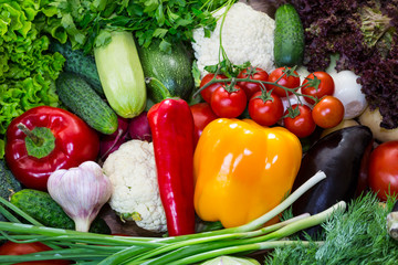 Fresh vegetables background close-up of tomatoes, cucumbers, onions, mushrooms 