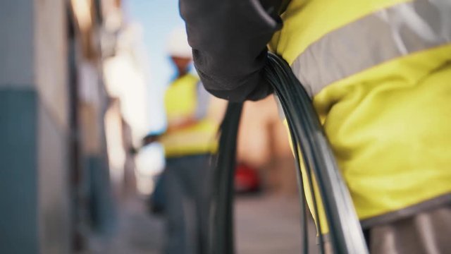 Close Up Technicians Working with Electrical Cables on Residential Street
