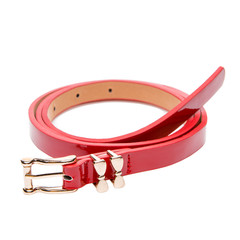 red female belt with a golden shiny buckle, laid on the ring, on a white background
