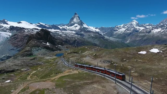 Aerial shot following the Gornergratbahn train descending to Zermatt, Switzerland