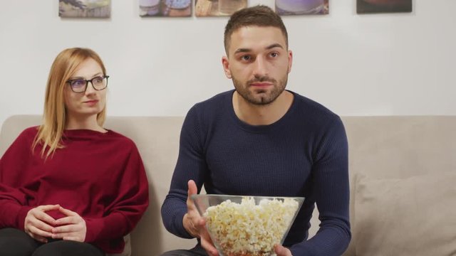 Scared man throwing popcorn