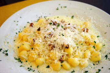 Plate of Italian potato gnocchi with gorgonzola cheese and walnuts