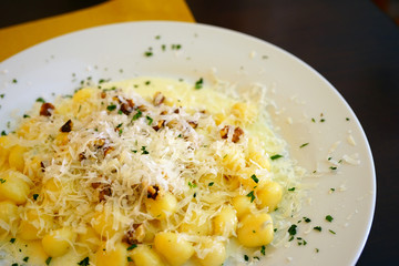 Plate of Italian potato gnocchi with gorgonzola cheese and walnuts