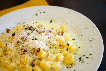 Plate of Italian potato gnocchi with gorgonzola cheese and walnuts