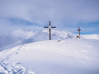Sybmolic cross on top of mountain