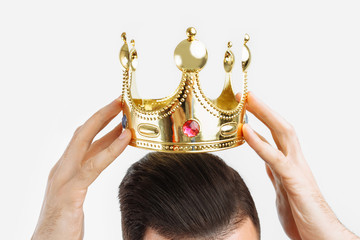 man on a white background wears a crown on his head, in a photo Studio