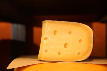 Delicious cheese in store, closeup. Dairy product