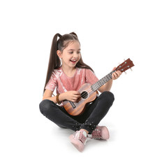 Little cheerful girl playing guitar, isolated on white