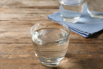 Glass of fresh water on wooden table