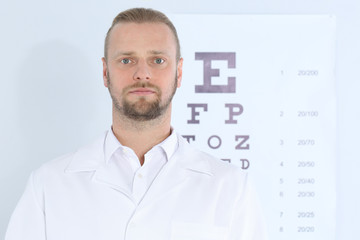 Fototapeta na wymiar Male children's doctor near eye chart in hospital