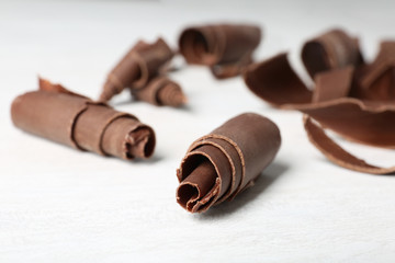 Chocolate curls for decor on table, closeup