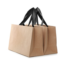 Paper shopping bags with handles on white background. Mockup for design