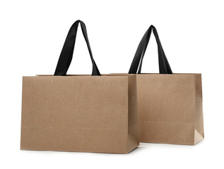 Paper shopping bags with handles on white background. Mockup for design
