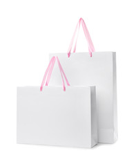 Paper shopping bags with handles on white background. Mockup for design