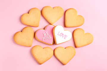 Naklejka na ściany i meble Decorated heart shaped cookies on color background, top view. Valentine's day treat
