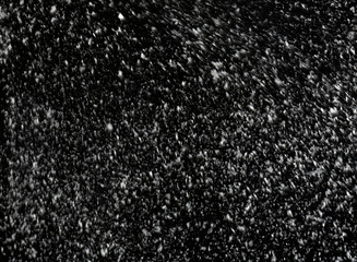 Snow flakes falling on black background. Winter weather