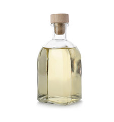Glass bottle of apple vinegar on white background