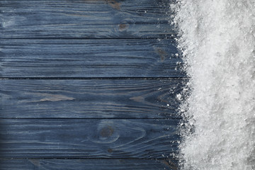 White snow and space for text on wooden background, top view - obrazy, fototapety, plakaty