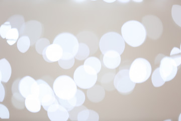 Blurred view of beautiful lights on gray background