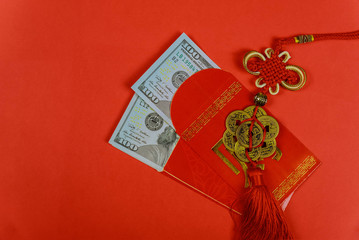 Money in red envelopes Chinese new year greeting gift, closed up of US dollar banknotes in red traditional envelopes,