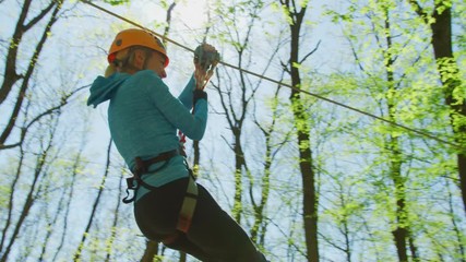 Woman on a zip-line in an adventure park