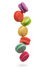 Close up. Colorful and falling french macarons isolated on white background. Copy space.