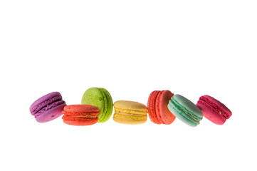 An assortment of bright colorful macaroons lined up in a row. Cookies isolated on a white background. Copy space.