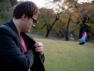 Fototapeta premium A man taking something out of his jacket pocket