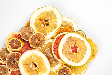 Dried slices of various citrus fruits on white background