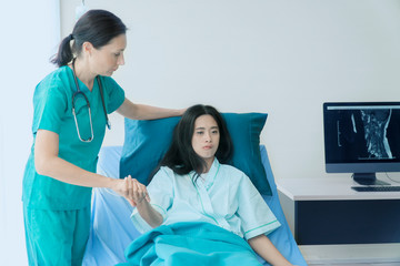 Experienced doctor middle ages of Russian doctor in lab coat her young Asian patient magnetic...