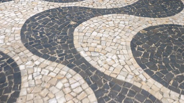 Walking on Copacabana Beach mosaic sidewalk, Rio de Janeiro, Brazil