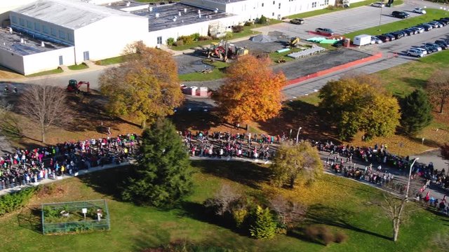 Aerial View of Crowd Jogging Through Beautiful Fall Parkland While on a Charity Run