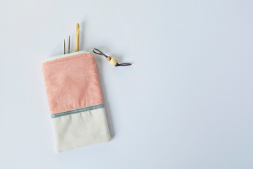 Peach and gray handmade knitting needles pouch over white