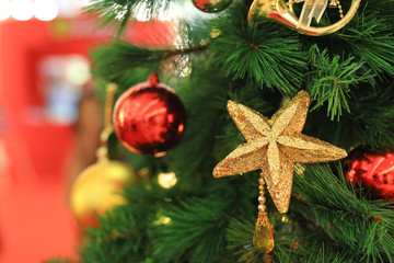 Christmas balls and light hanging on pine tree branches. Xmas winter background.