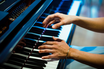 pianist hands on the background of the piano keys