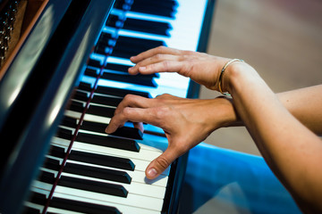 pianist hands on the background of the piano keys