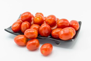 Fresh Tomato in a ceramic cup isolated white background 
