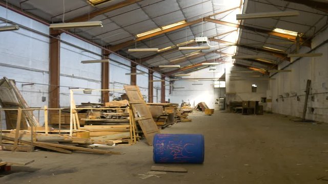 Panoramic view of an abandoned shed with a lot of pieces of woods. Old adandoned sawmill.