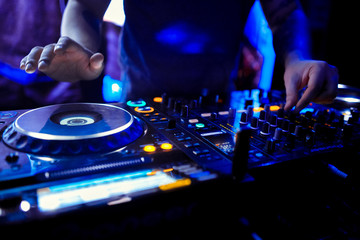 Fototapeta na wymiar Dj mixes the track in the nightclub at party