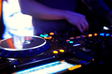 Naklejka premium DJ console cd mp4 deejay mixing desk Ibiza house music party in nightclub with colored disco lights.