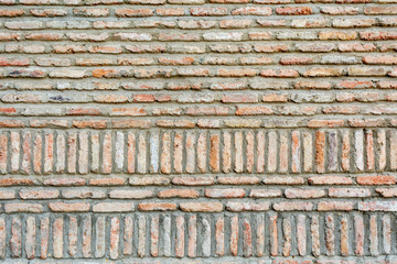 Abstract background of ancient old brick layered ground with weathered surface 