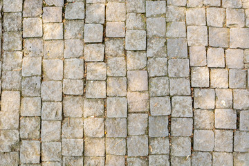 Abstract background of an old stone pavement with weathered texture surface