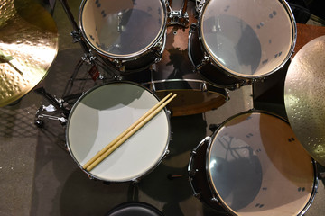 Closeup of drumsticks lying on the professional drum set. Drummer equipment. 