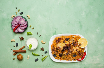 Traditional Arabic food: kabsa with chicken on a plate.
