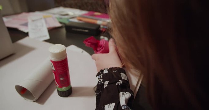 Little girl crafting homemade Christmas ornaments for the Christmas tree. 4K.