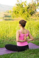 Fototapeta na wymiar Female practice yoga stretching at outdoor location.